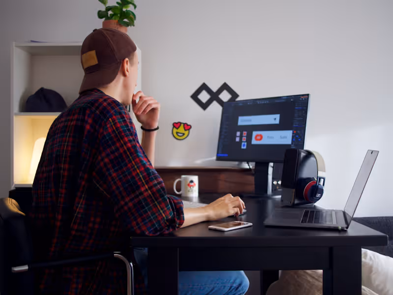 Freelancer working at a minimalist desk with monitor, web designer at work